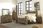 Trinell Brown Wood Queen Poster Bed